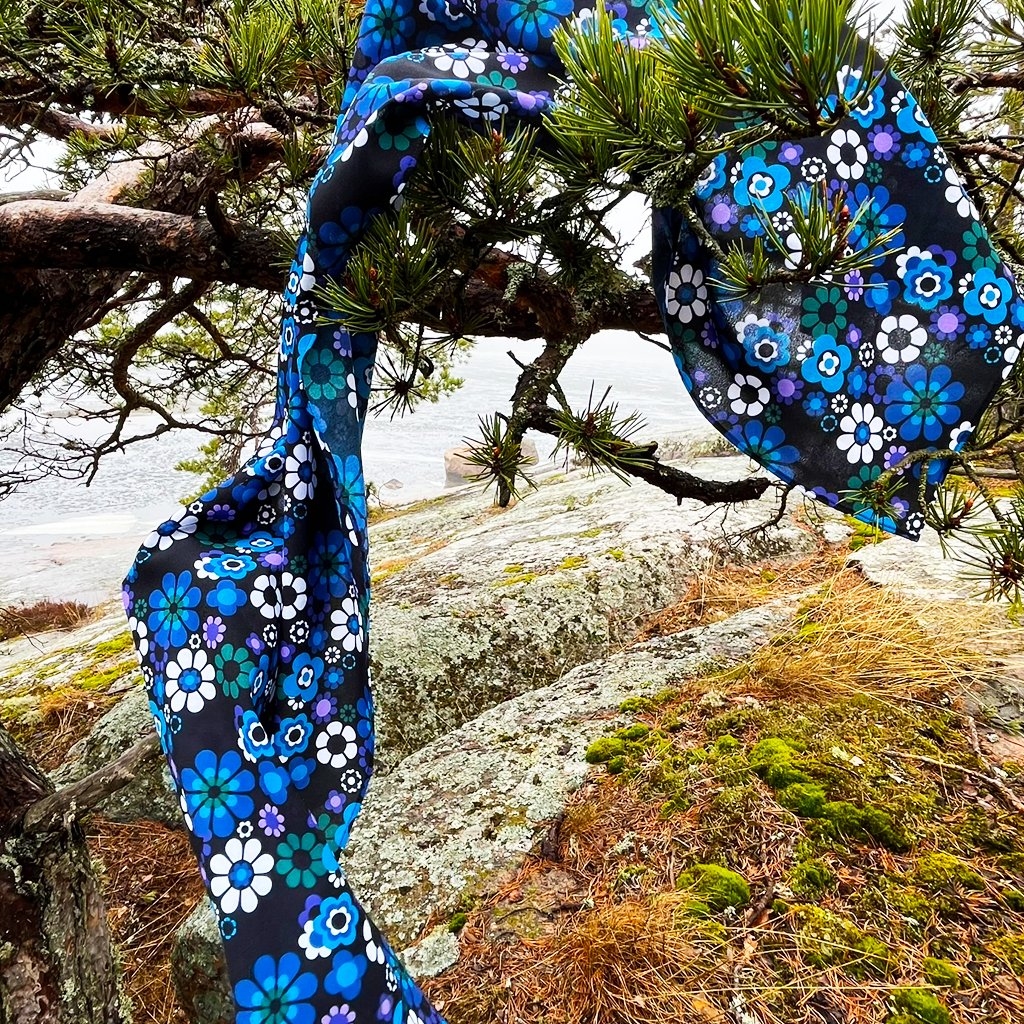 A colorful scarf hanging from a tree branch