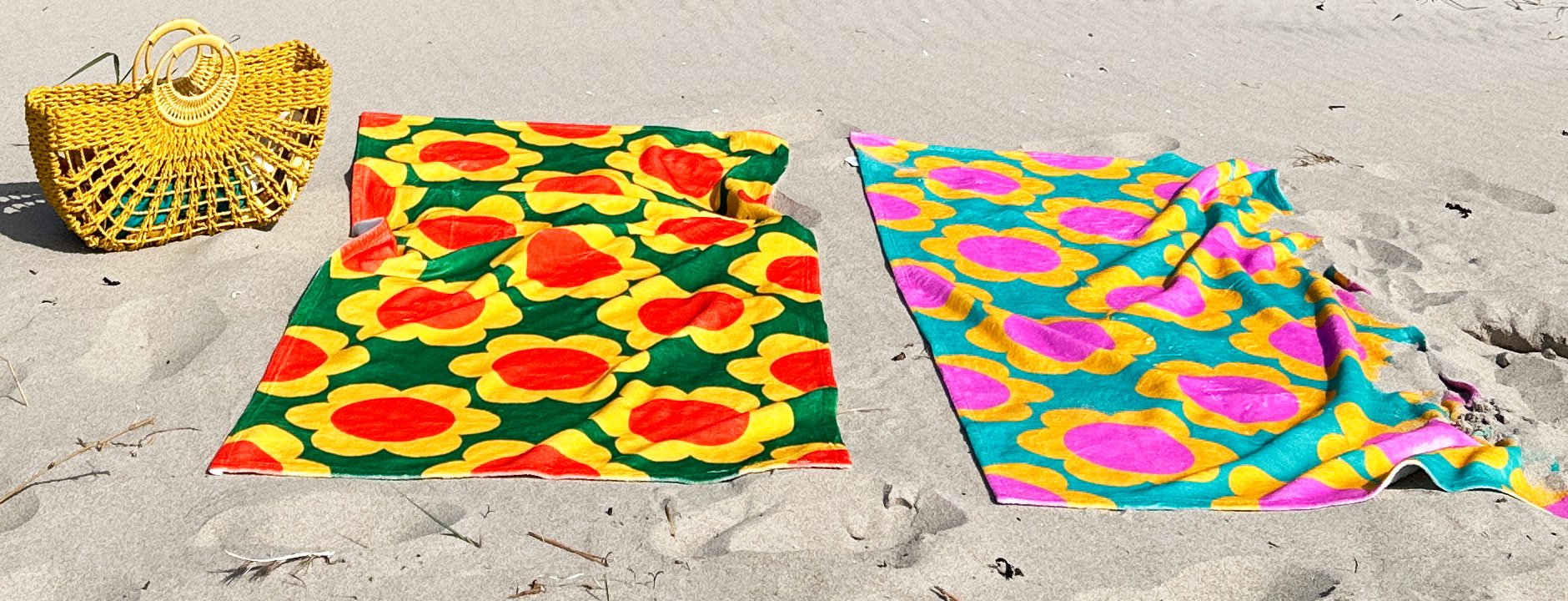 Colorful SHALMIAK towels on the beach.