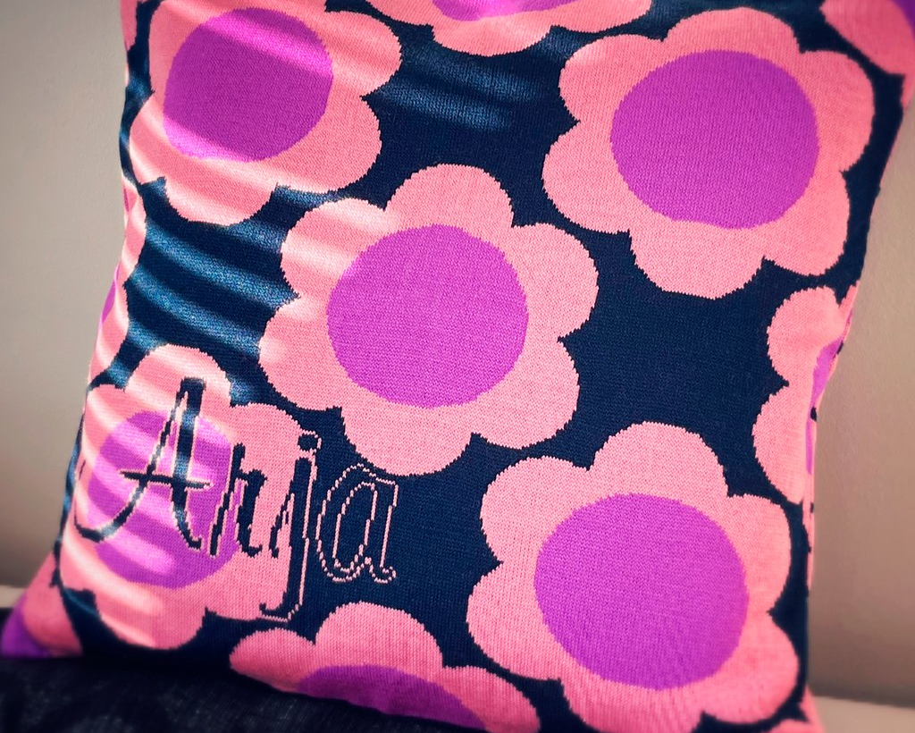 Personalized pillowcase with purple flowers and customized name.