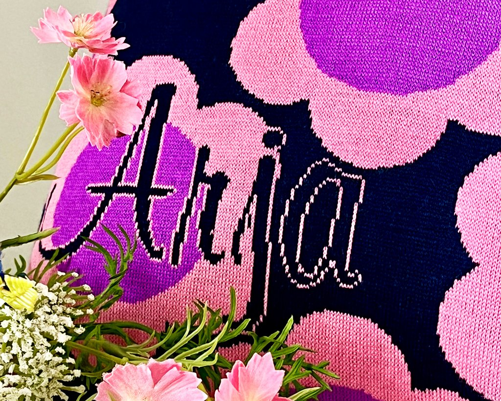 A closeup of a personalized pillowcase with customized name.