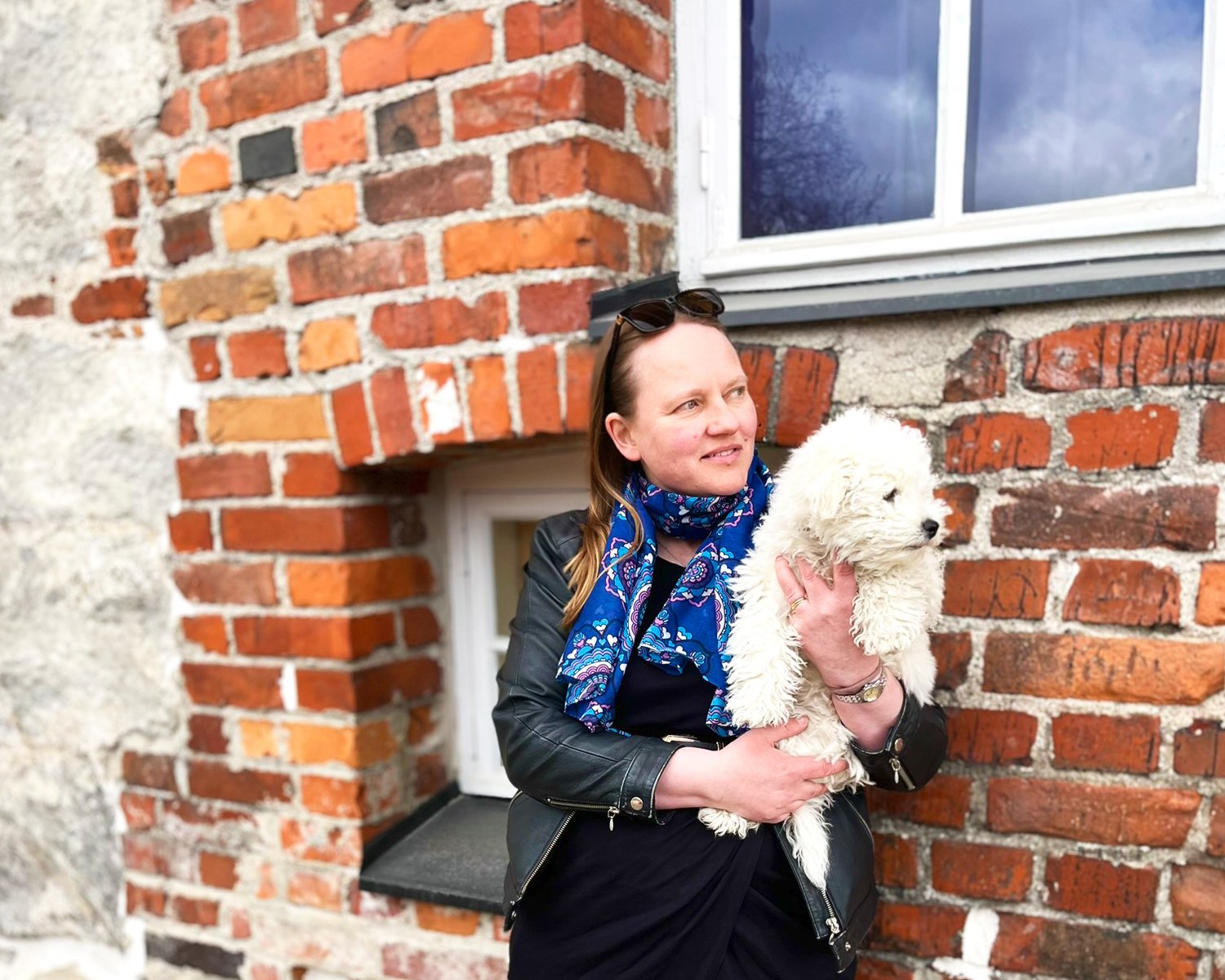 A colorful scarf & designer Sari Ahokainen with her dog.